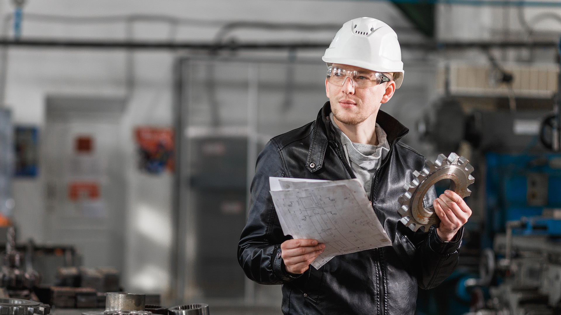 A lubrication professional holding a gear wheel